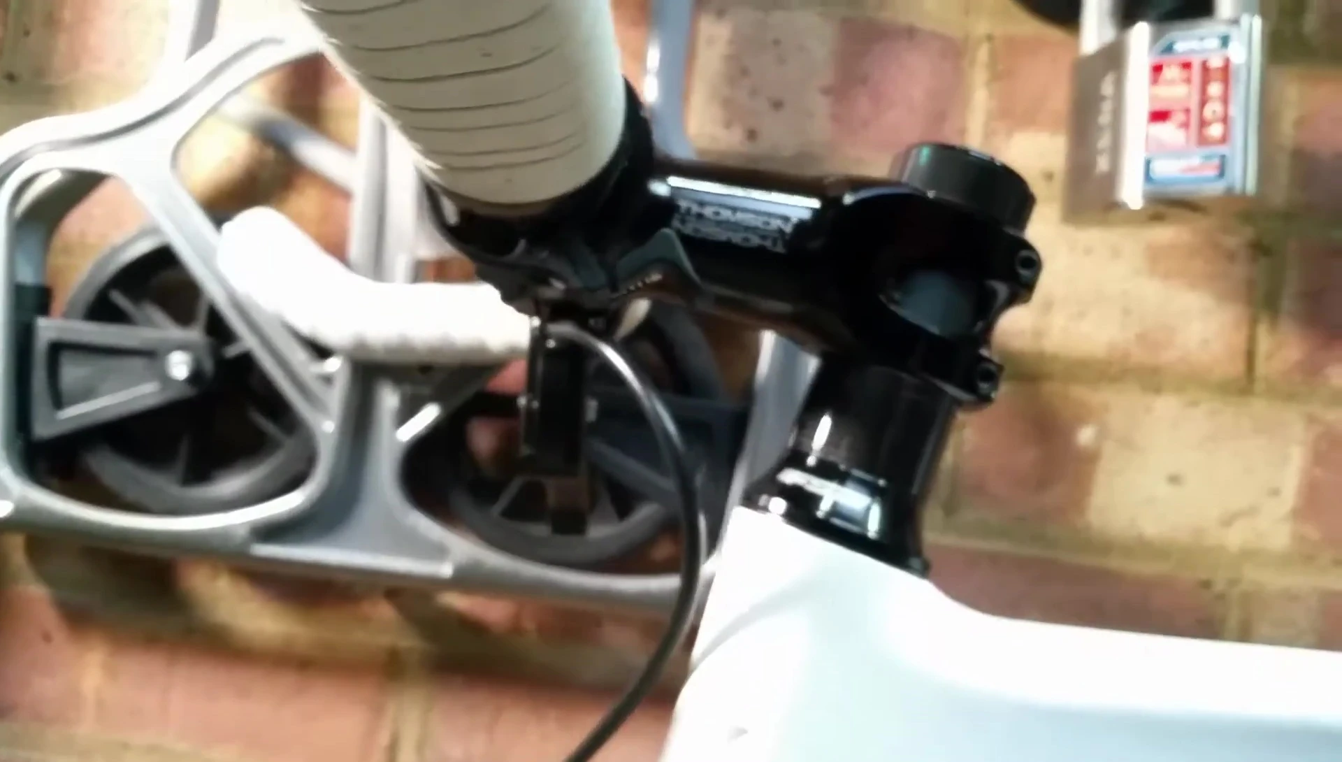 The Knog Oi bell mounted on the handlebars with a downward tilt.