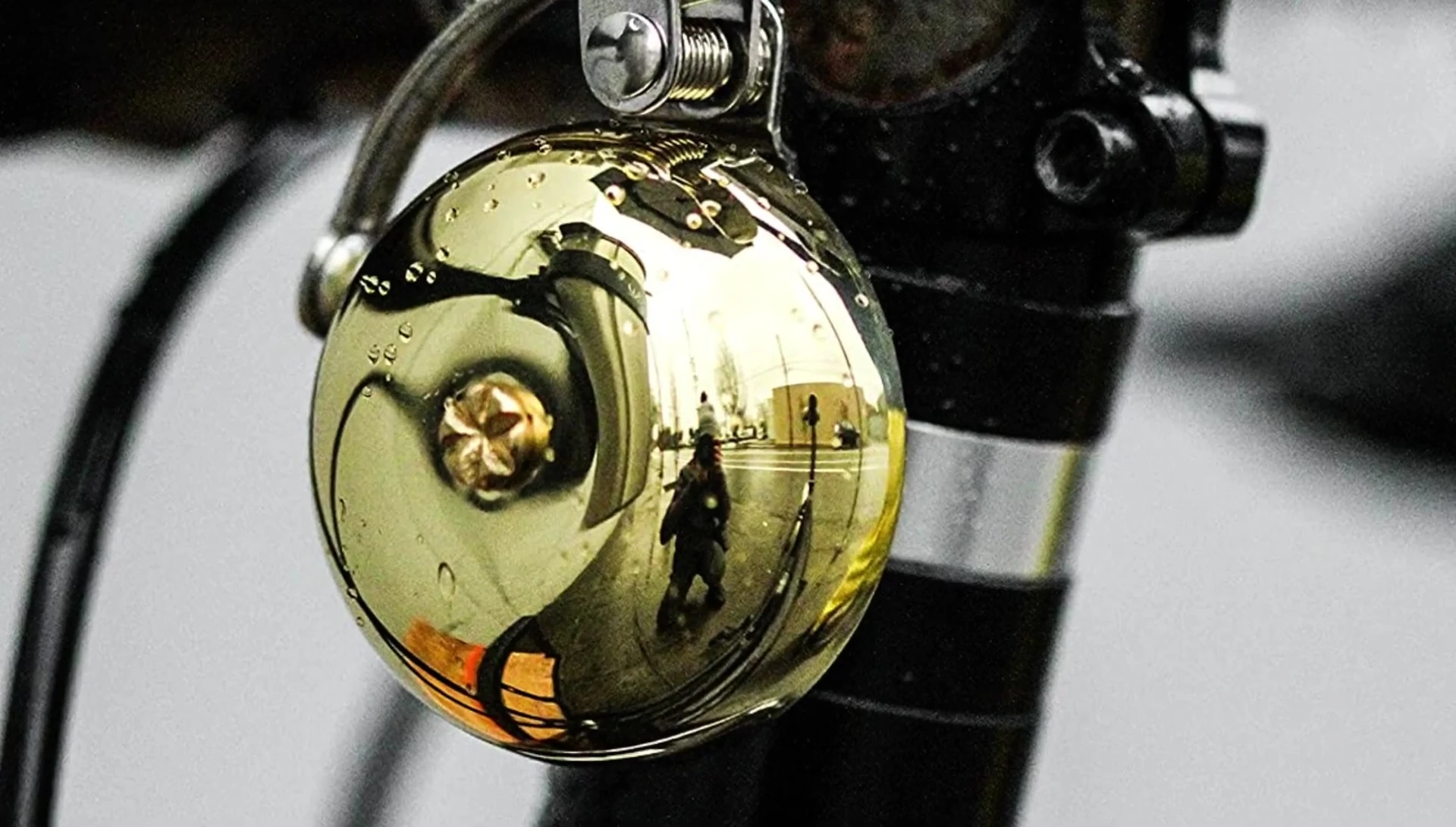 Close-up highlighting the brass dome and striker of the Alexander Graham Bell.