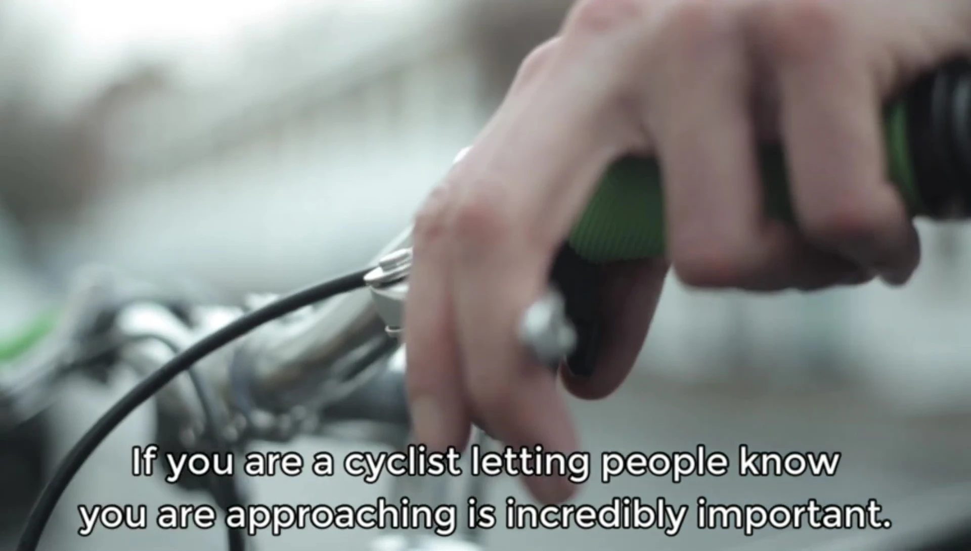 Rider demonstrating the thumb activation of the Trigger Bell V6.
