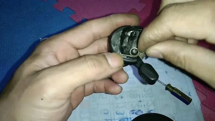 Reassemble the bell components. Pay close attention to the spring placement (small spring first, then the larger one).