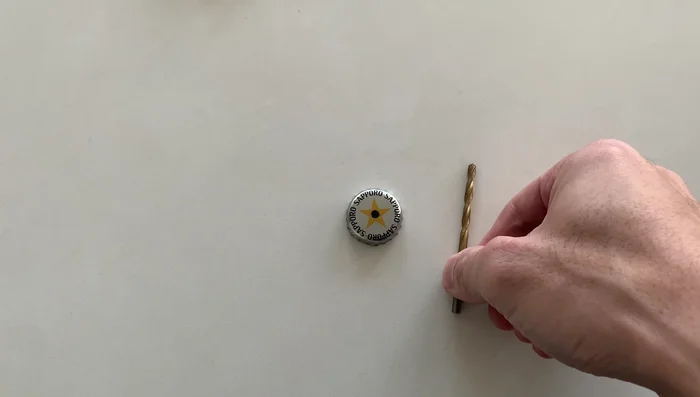 Drill a hole in a cap using a 4mm drill bit.