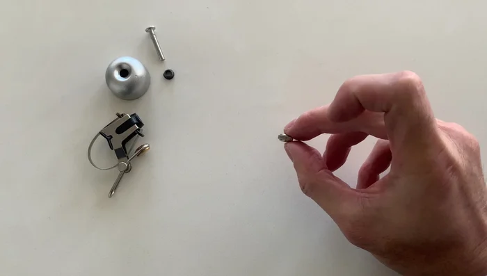 Place the cap back on and screw on the nuts, ensuring they are tight.