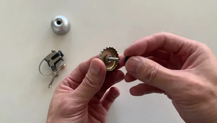 Place the cap back on and screw on the nuts, ensuring they are tight.