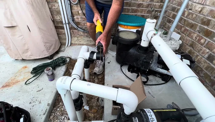 Use a hammer and screwdriver to pry off the cut union piece.