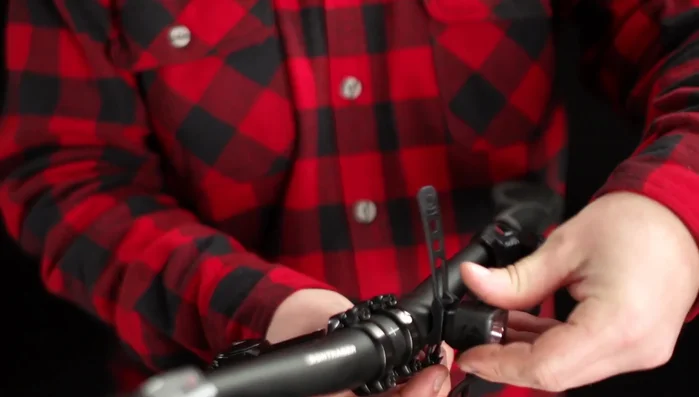 Stretch the rubber straps around the handlebar and catch the hook securely through a notch.