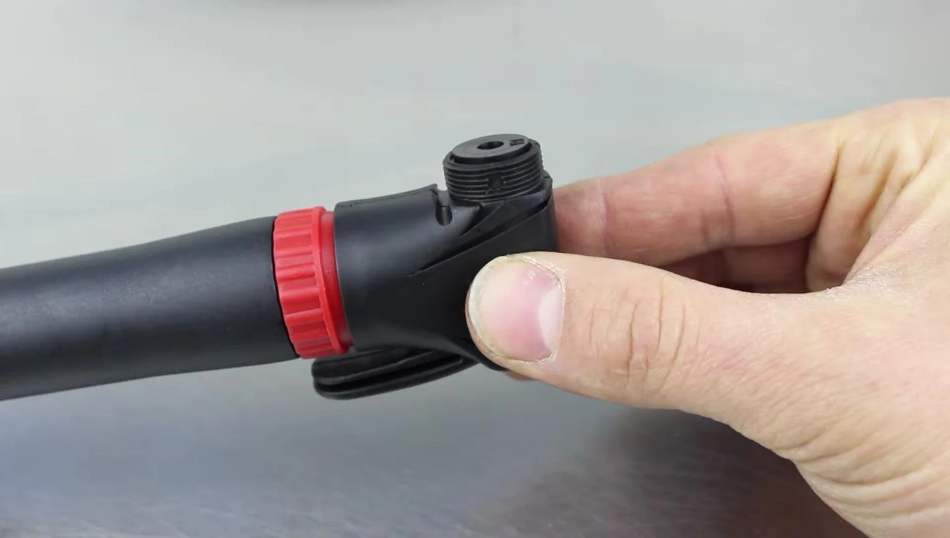 Removing the rubber piece from the bicycle pump head.