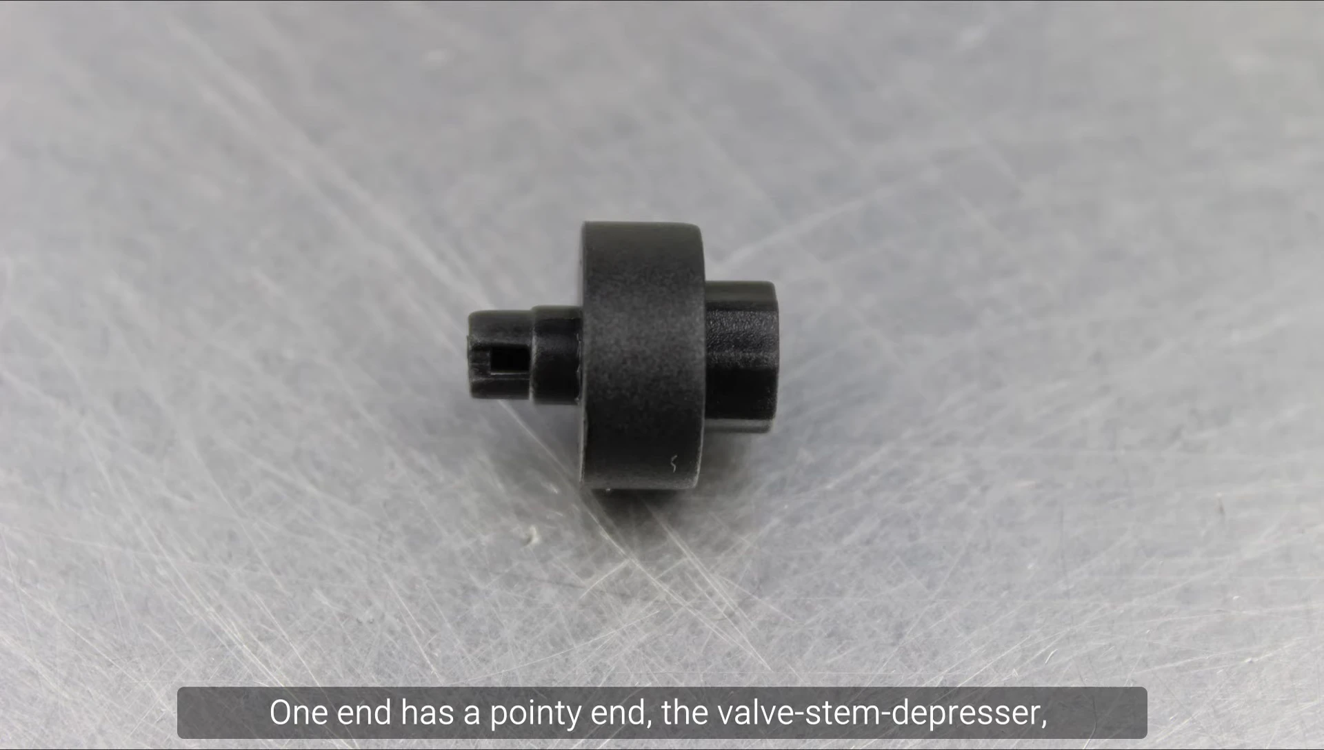 Showing the plastic piece with valve stem depressor and its insertion into the pump head.