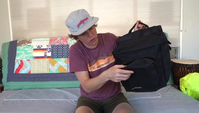 Discussion of the material (600D polyester), water resistance (not waterproof), and budget-friendly nature of the bags.