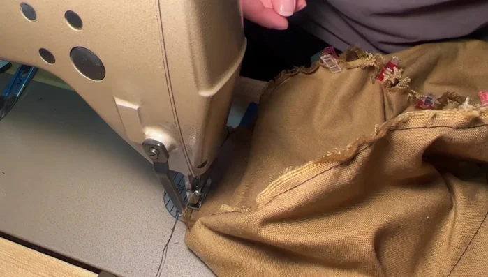 Sew a new stitch line approximately ⅛ inch from the original stitch line. Keep the fabric flat under the presser foot as you sew.