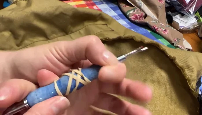 Carefully remove the remaining stitches in the damaged area using a seam ripper.