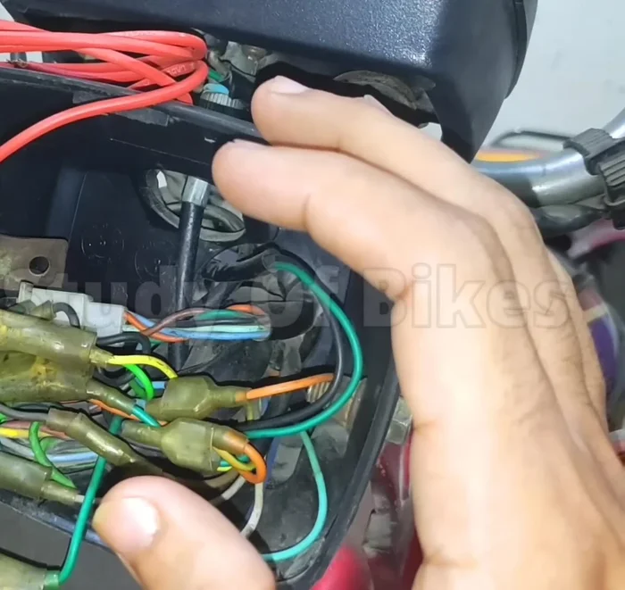 Identify the problem: Dim headlight in an old bike due to weak current in the yellow wire.