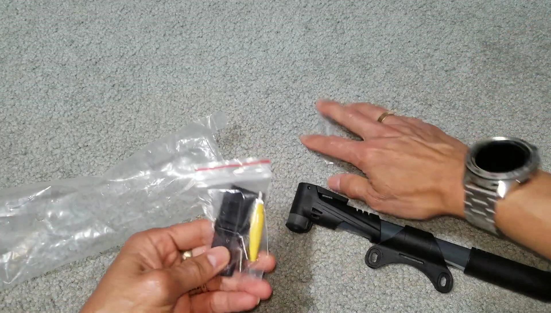 The included accessories such as the Velcro strap and valve adapters.