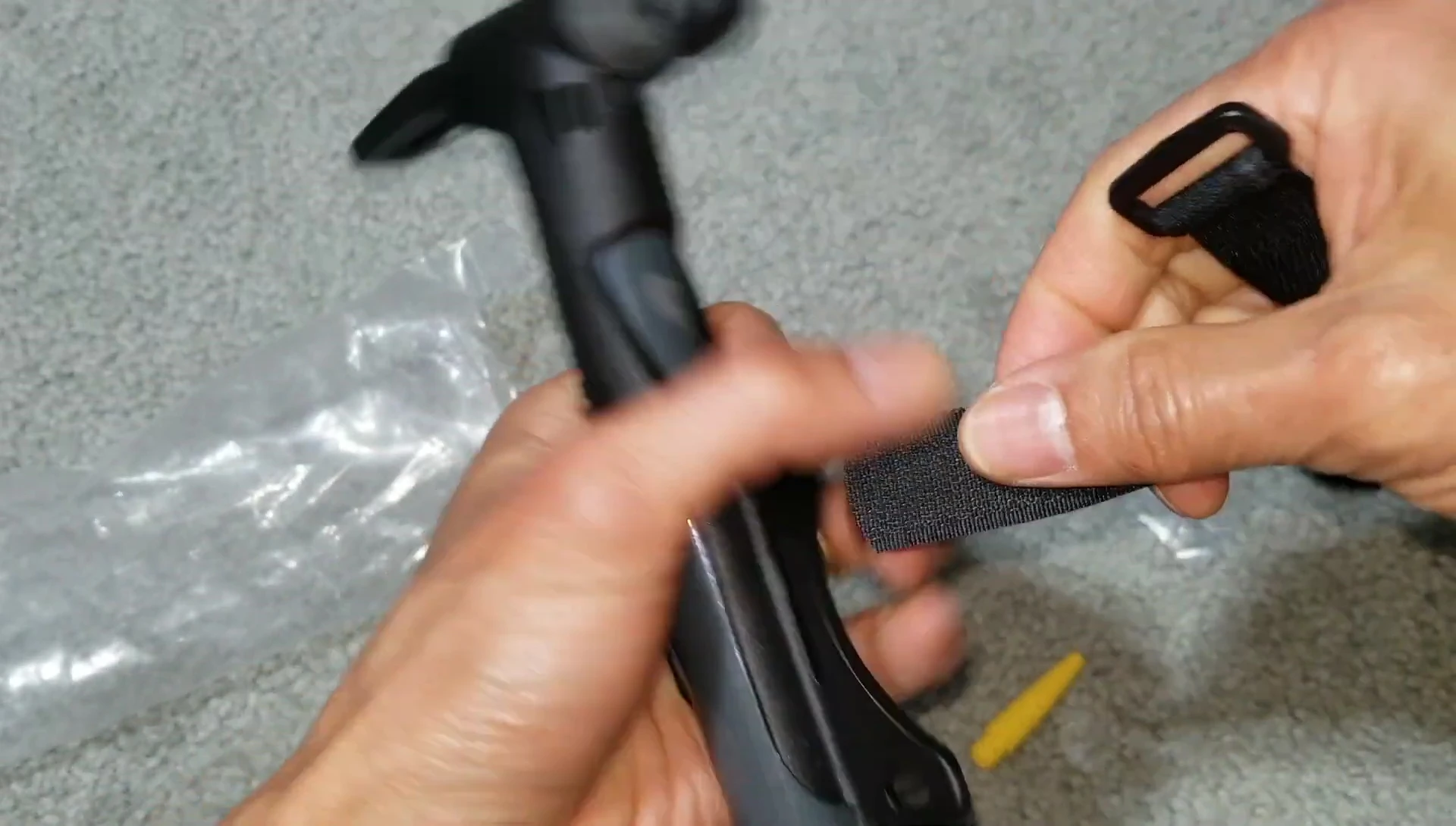 Demonstrating how to use the Velcro strap to attach the pump to the bicycle.