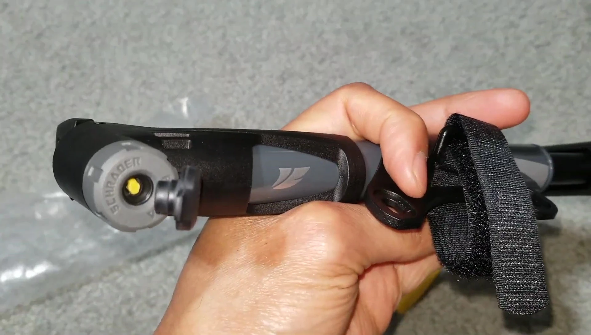 Preparing to attach the pump head to the bike tire valve.