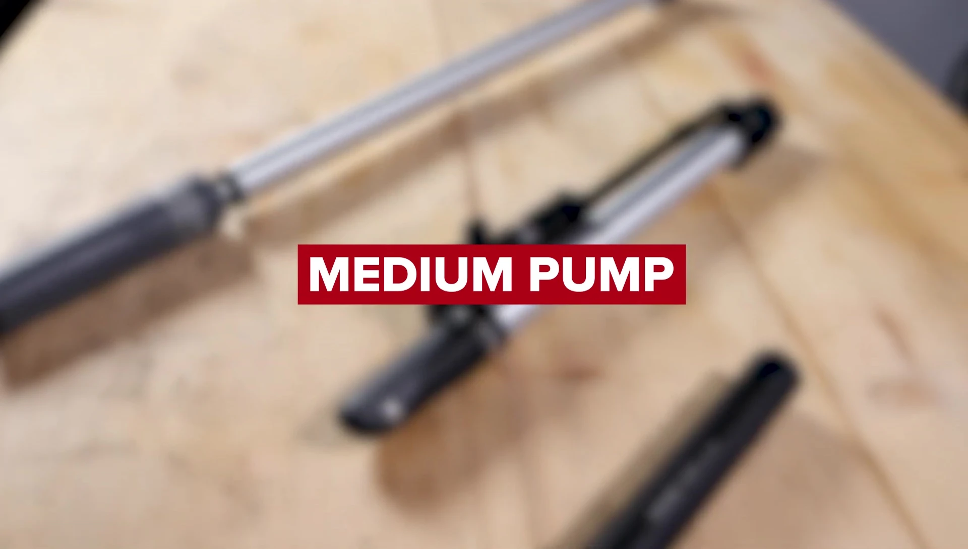 A mid-size bike pump with a footrest and flexible hose.