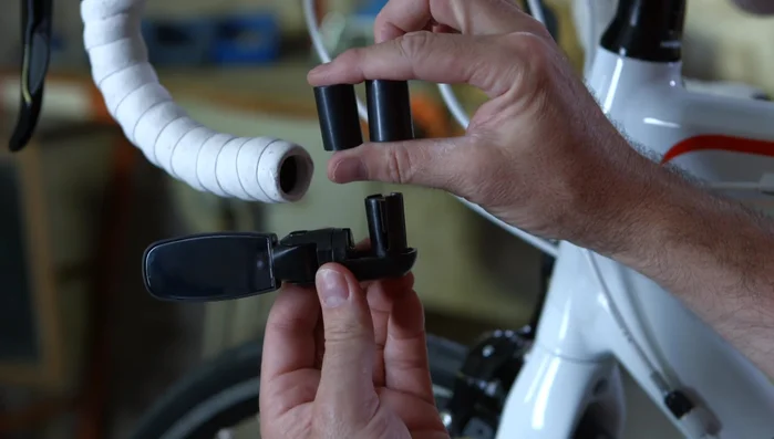 Insert the mirror into the hole and tighten it with a screwdriver.