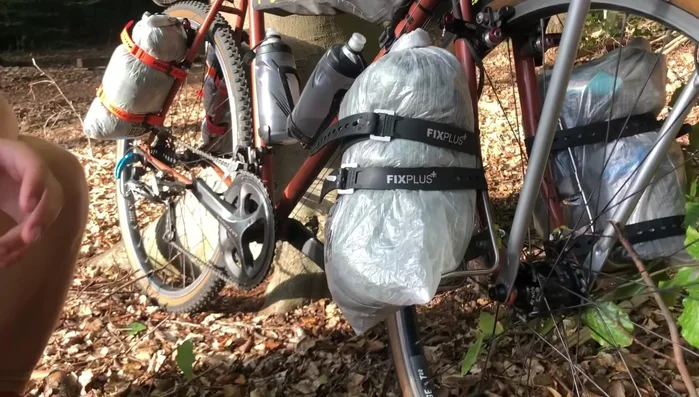 Attach lightweight, waterproof dry bags (e.g., Cuban fiber) to the rack using straps and buckles.
