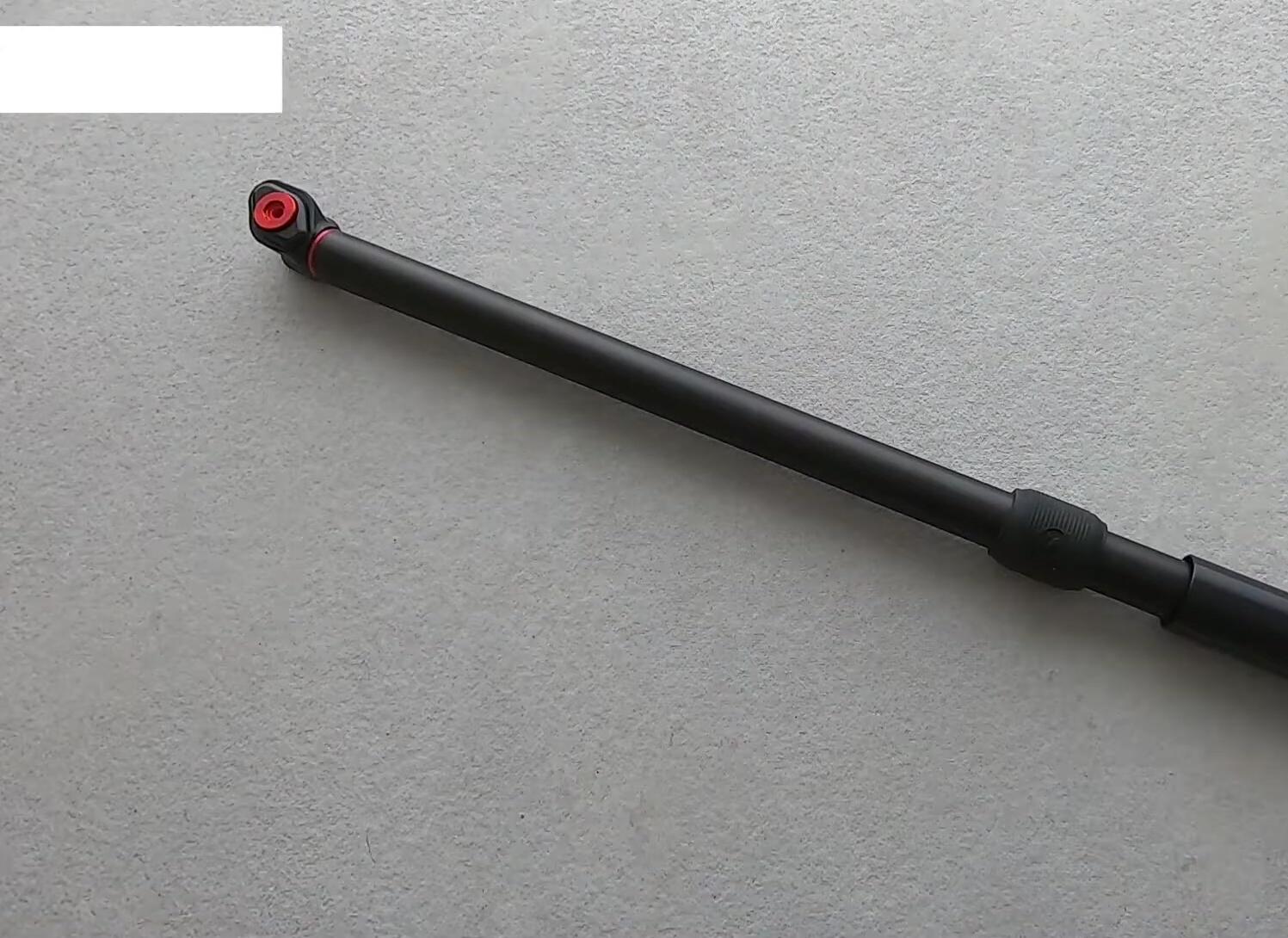 Close-up of the pump, showcasing its aluminum construction and red accents