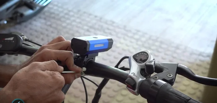 Tighten the cable ties, cut the excess, and mount the headlight.