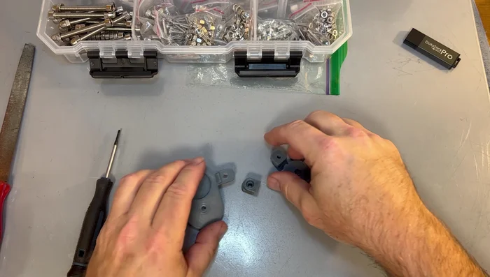 Assemble the replacement part using appropriate nuts and bolts. Consider using a heat gun to assist with nut insertion if needed.