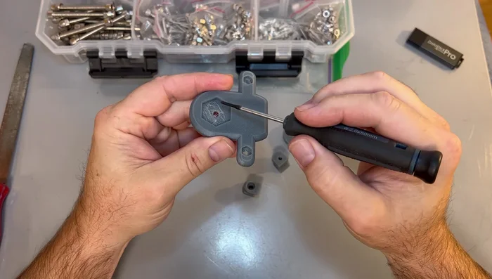 Assemble the replacement part using appropriate nuts and bolts. Consider using a heat gun to assist with nut insertion if needed.