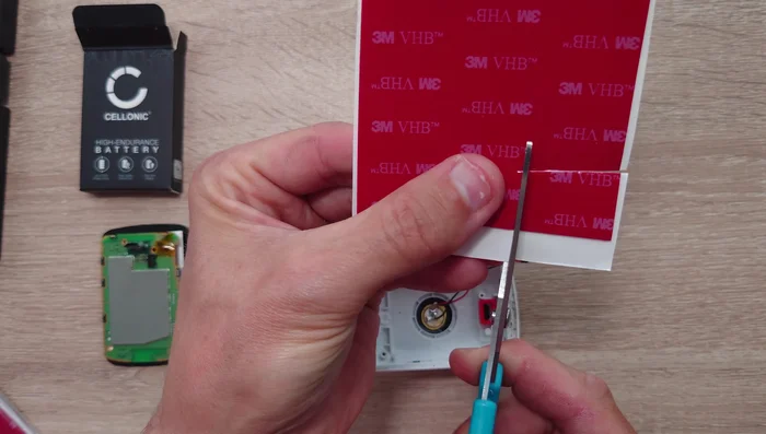Cut a piece of adhesive to fit around the inner part of the plastic unit, leaving a border of 2-3 millimeters.