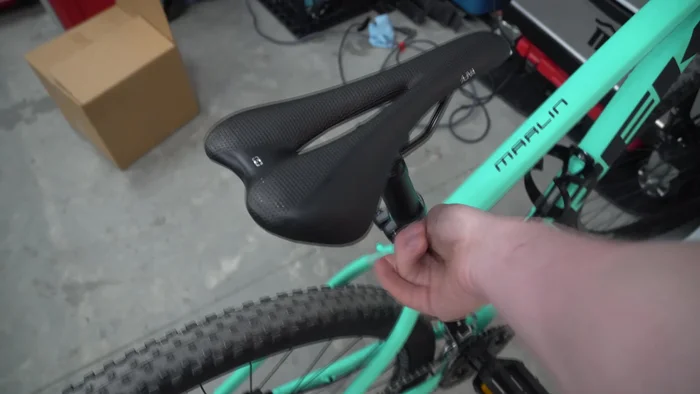 Unscrew the seat from the rails by hand.