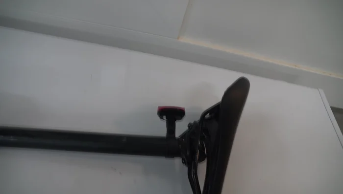 Unscrew the seat from the rails by hand.