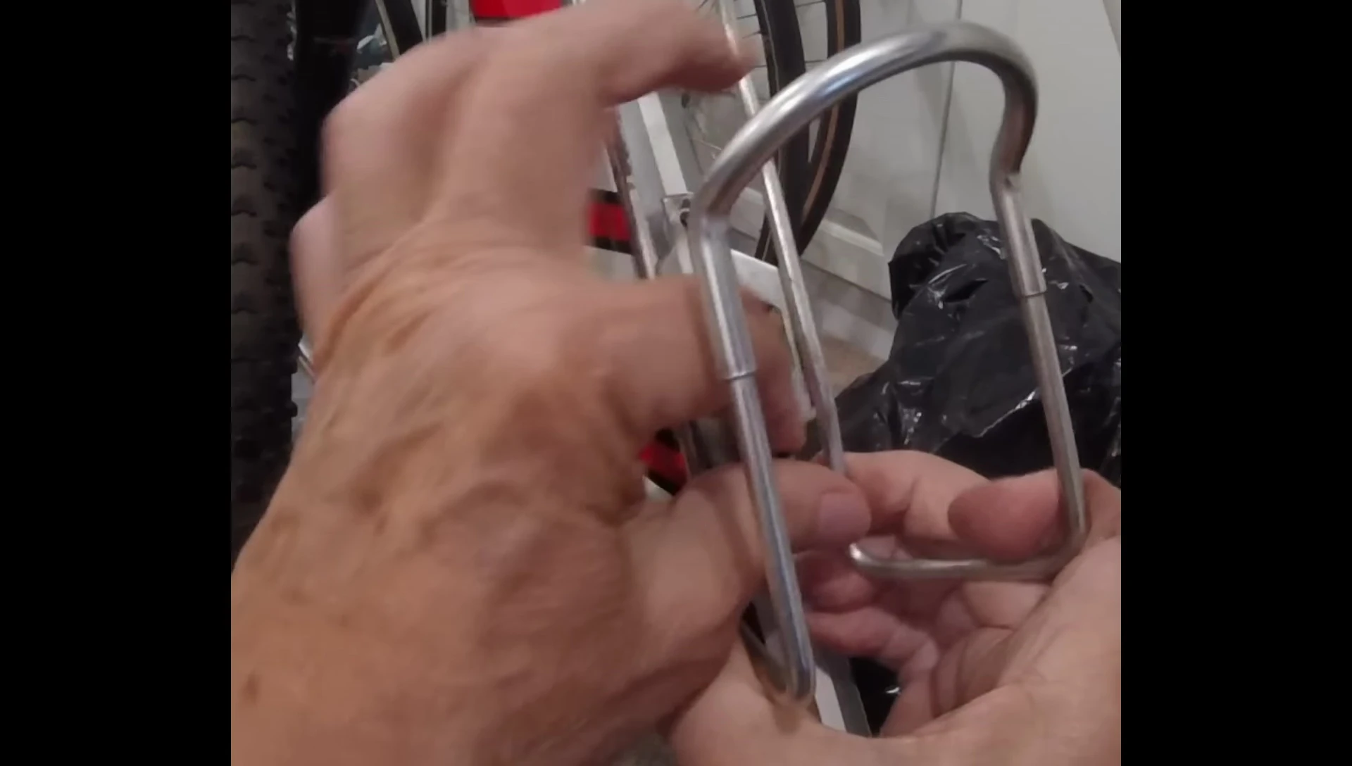 Removing the water bottle cage to install the mounting bracket.