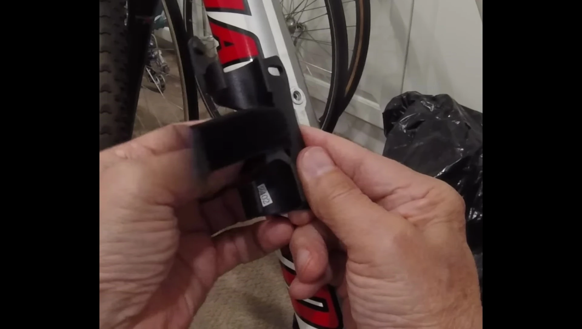 Showing how to correctly thread the strap through the bracket.
