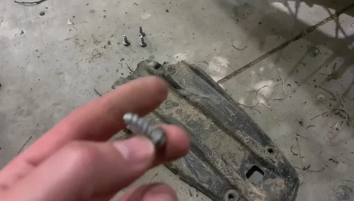 Disconnect the fender from the bottom of the bike by removing an 8mm bolt in the center.