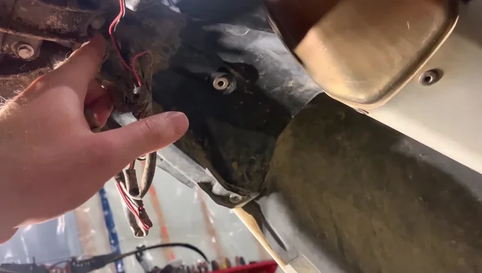 Disconnect the fender from the bottom of the bike by removing an 8mm bolt in the center.