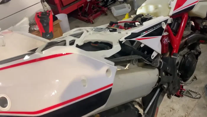 Remove the fender completely.