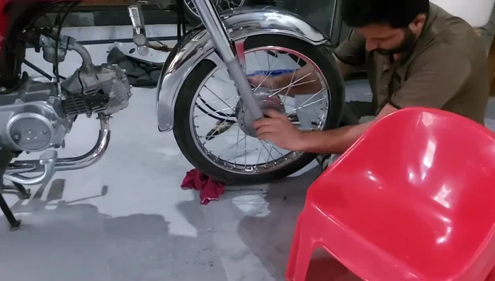 Reattach the mudguard to the motorcycle.
