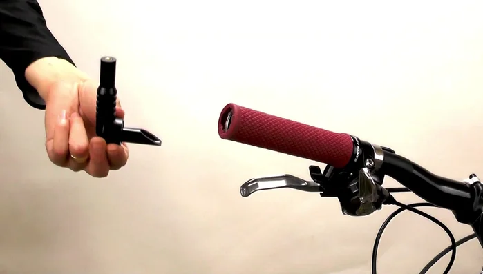 Insert the long bolt through the mirror base and wedge, then screw it into the barrel nut. Pull the wedge onto the barrel nut to secure.