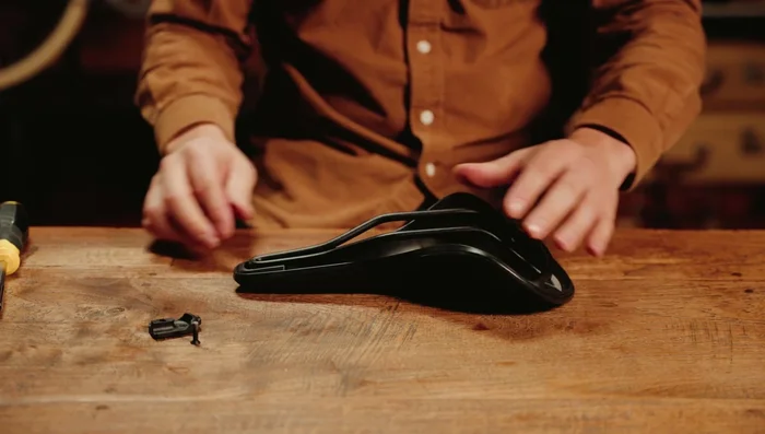 Close down the nose piece and tighten the bolt while holding the nose of your saddle.