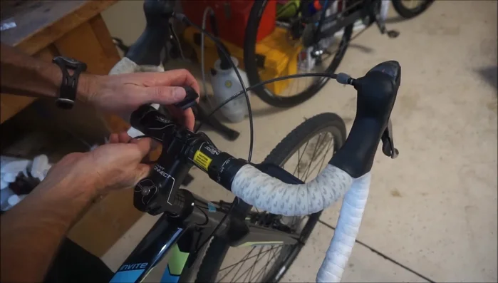 Attach the head unit to the mount using cable ties or an O-ring, ensuring it doesn't interfere with cables or hand position.