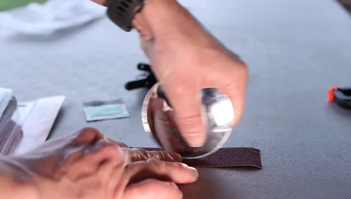 Sand down the new mirror glass if necessary to ensure a proper fit in the assembly.