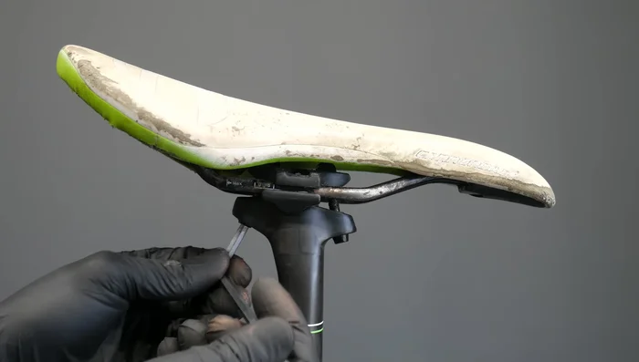 Loosen the bolt on one side.