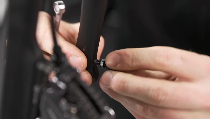 Tighten the eye bolts locking nuts using the 8mm open-end wrench.