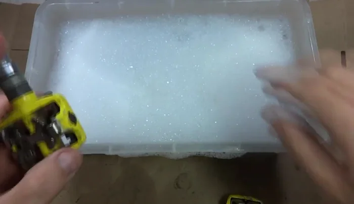 Clean the outside of the pedals with warm soapy water and degreaser, using brushes (65.309s)