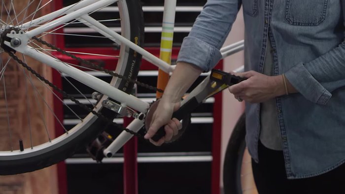 For the right pedal (chain side), turn the wrench to the left to loosen it. For the left pedal, turn the wrench to the right to loosen it.