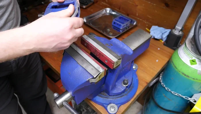 Remove the bearings, carefully supporting the axle to prevent them from falling out. Use a container to collect the bearings.