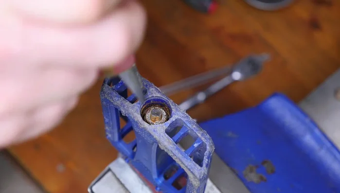 Remove the bearings, carefully supporting the axle to prevent them from falling out. Use a container to collect the bearings.