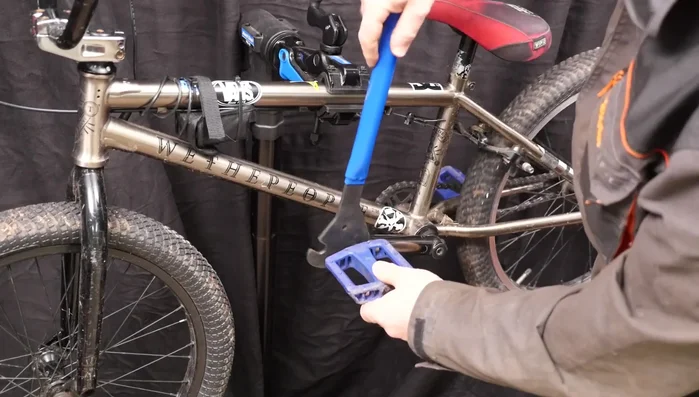 Use the wrench at a low angle to the crank for better leverage.