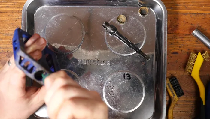 Insert the axle through the bearings.