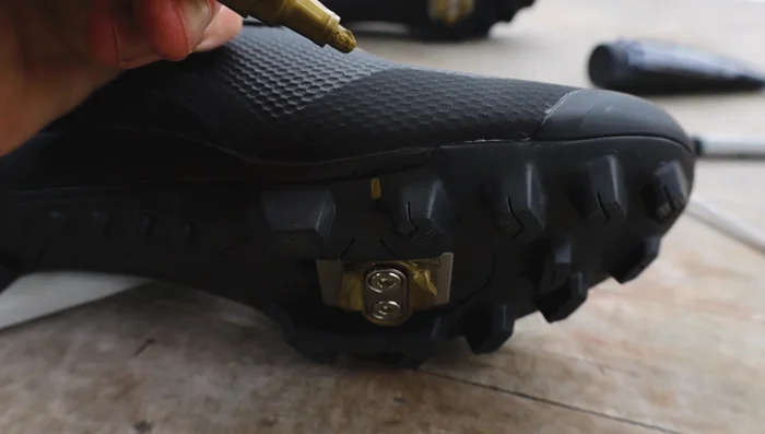 Check both shoes in the tool to ensure cleat positions match, using the center line to align shoes.