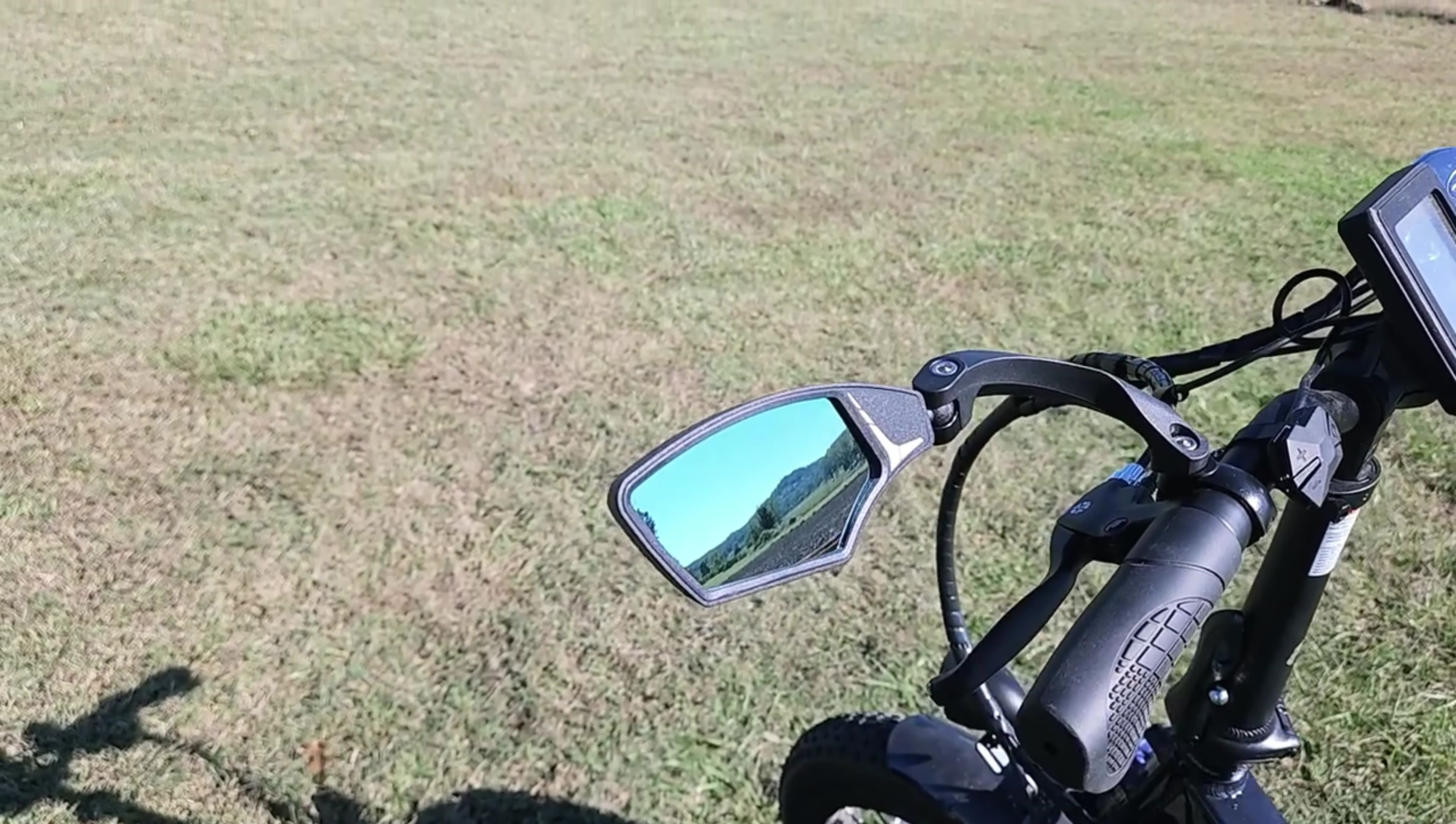Close-up of the mirror's glass, showcasing its tamper-resistant and anti-glare properties.
