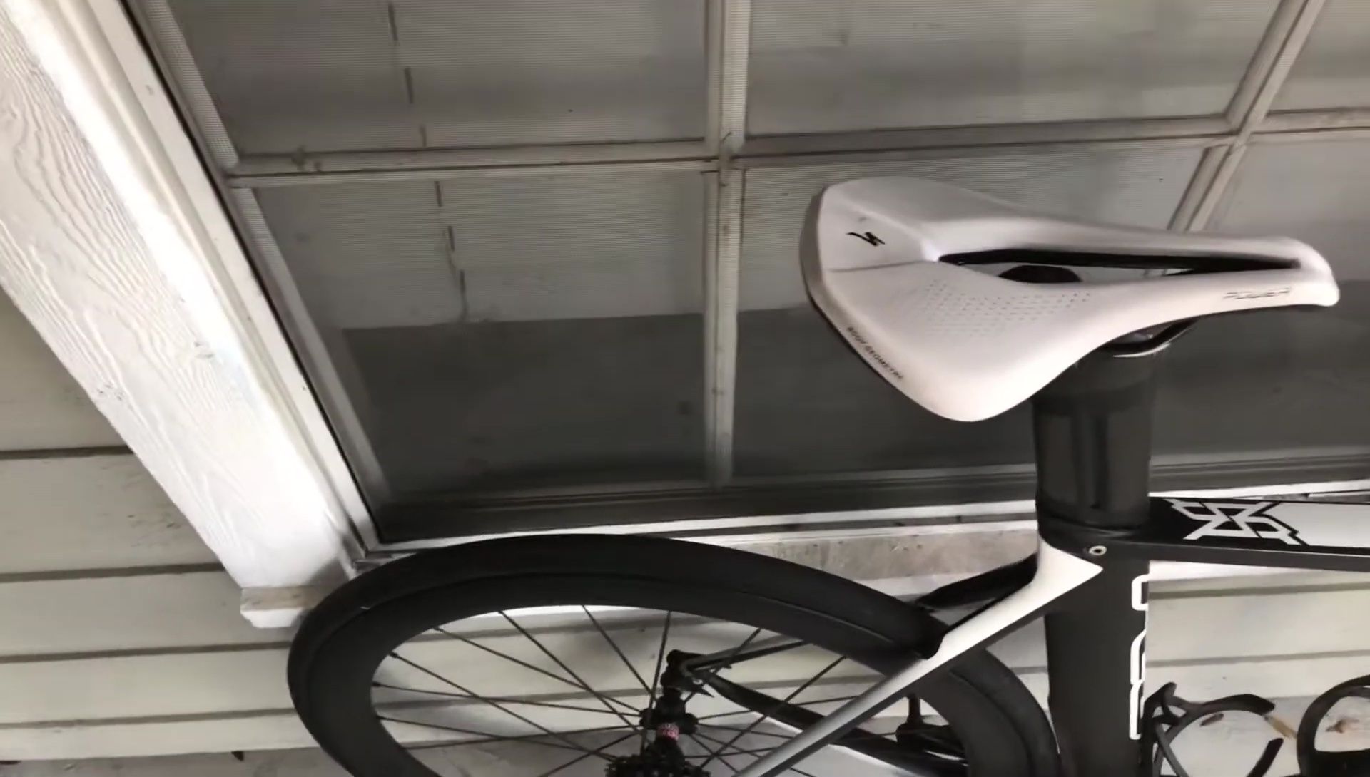 Close-up shot highlighting the carbon shell and titanium rails.