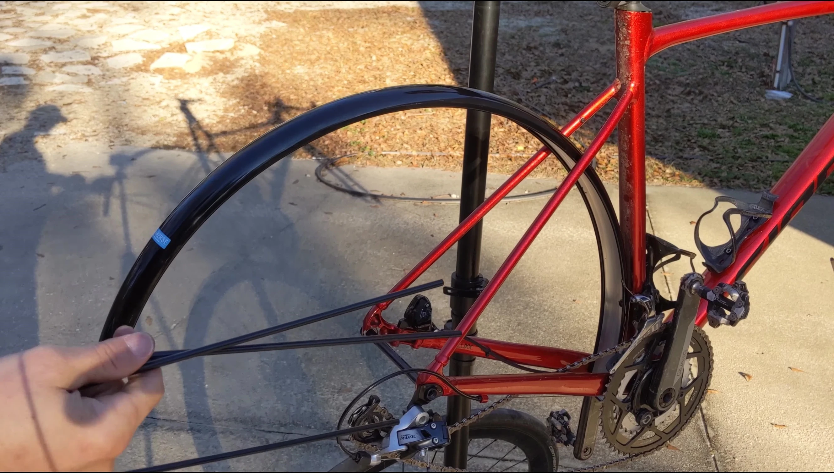 The fender stays are being installed on the bike frame.